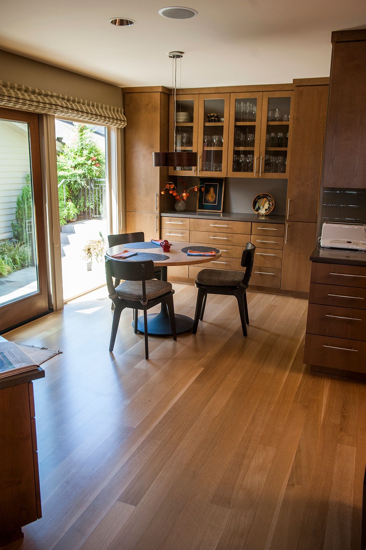a dining room with a table and chairs and a sliding glass door