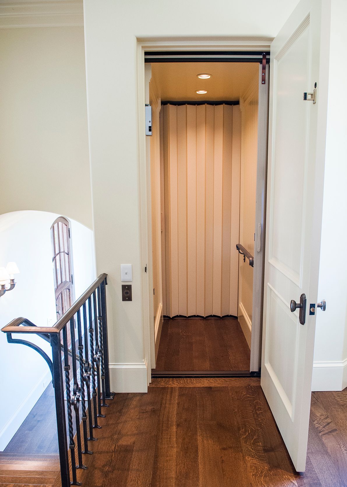 an elevator is going up a staircase in a house