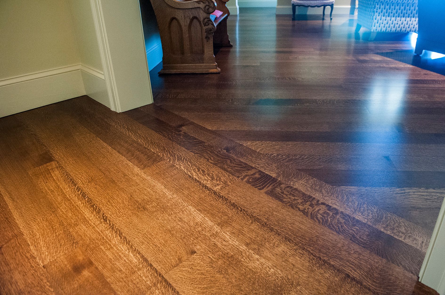 a wooden floor with stairs leading up to it in a room