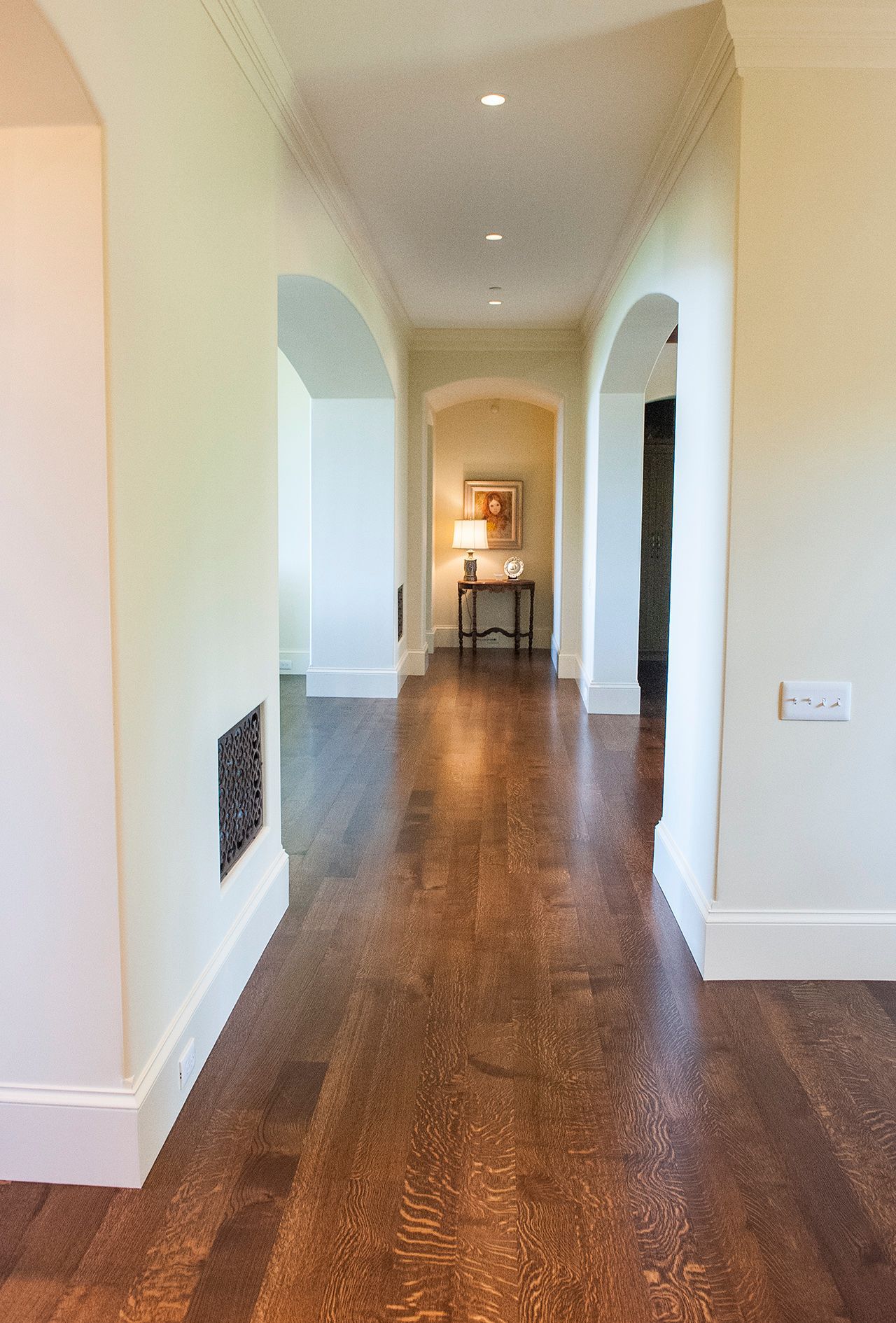a long hallway with wooden floors and white walls