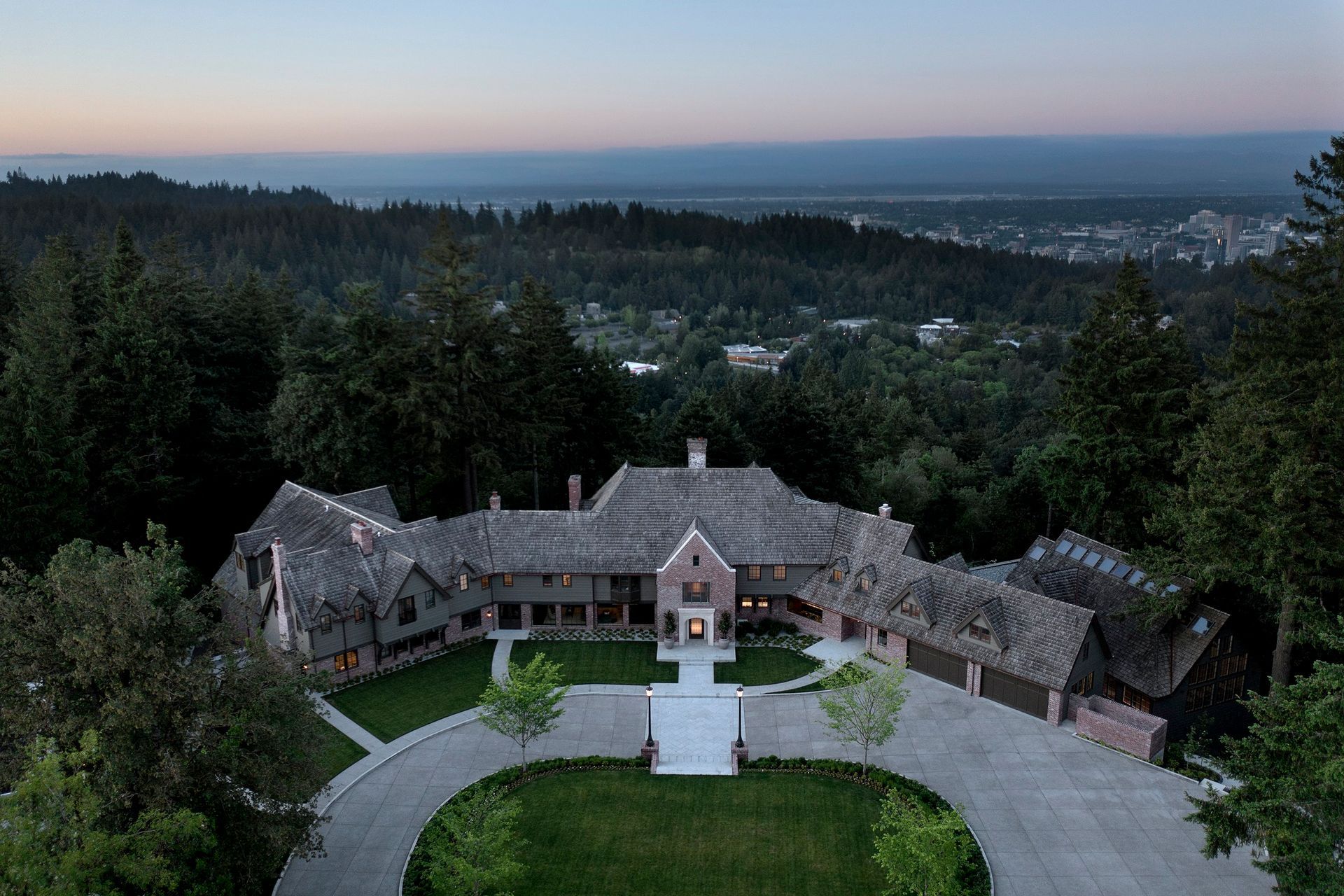 an aerial view of a large house surrounded by trees