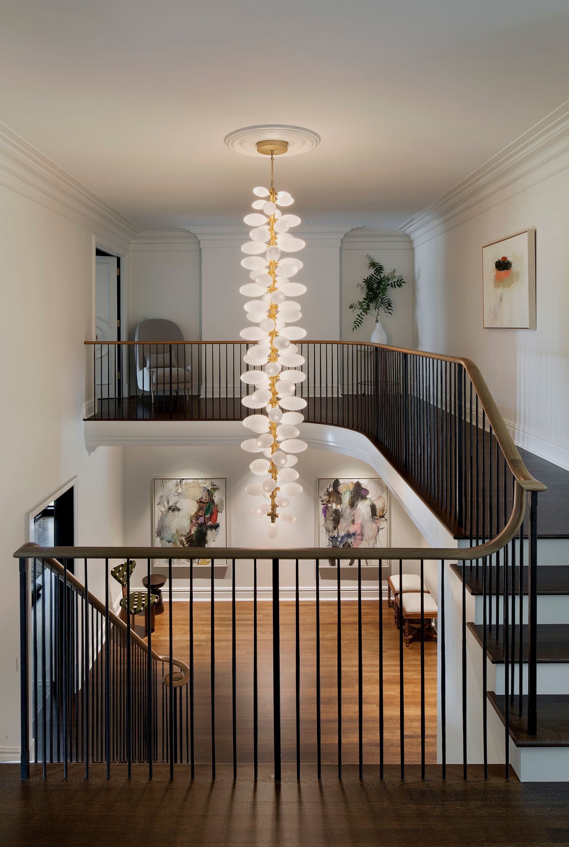 a staircase with a chandelier hanging from the ceiling