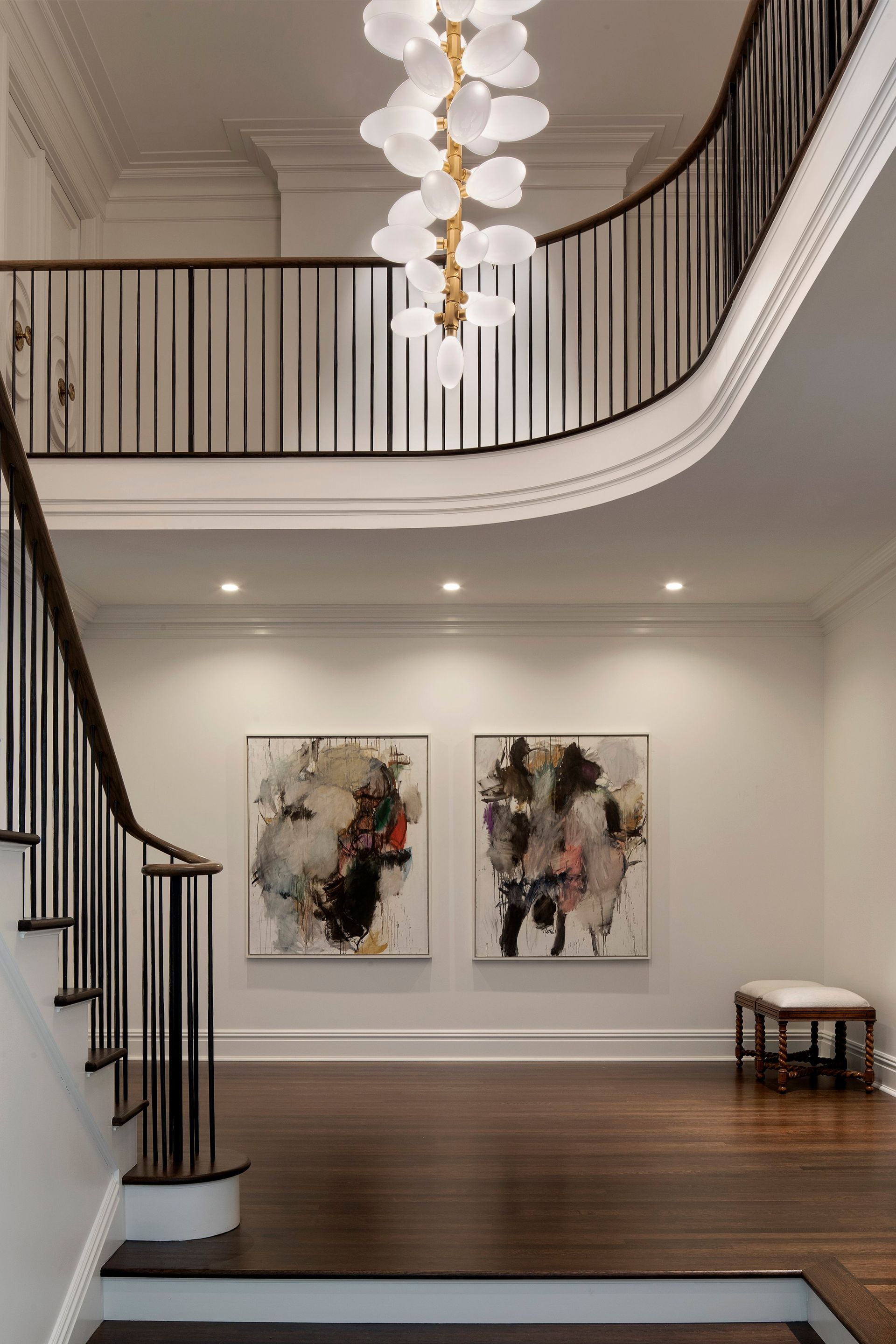 there are two paintings on the wall in the hallway