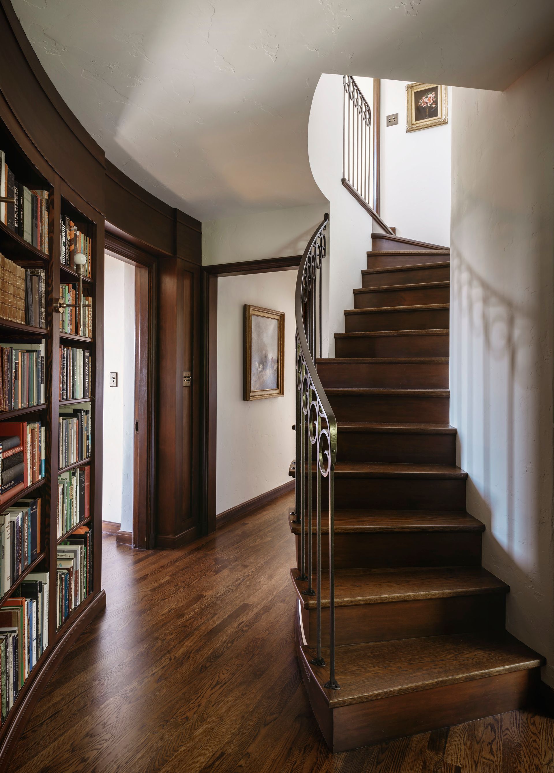 a spiral staircase leading up to the second floor of a house