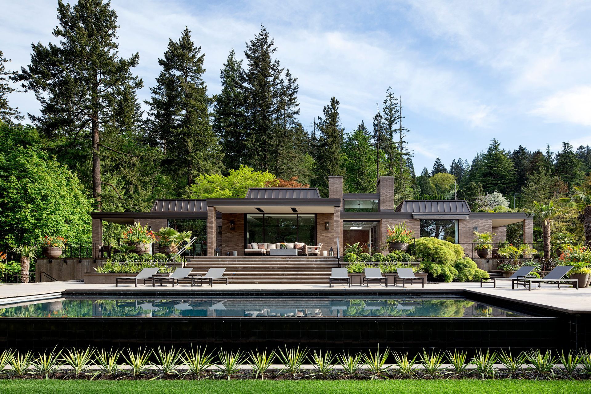 a large house with a large swimming pool in front of it