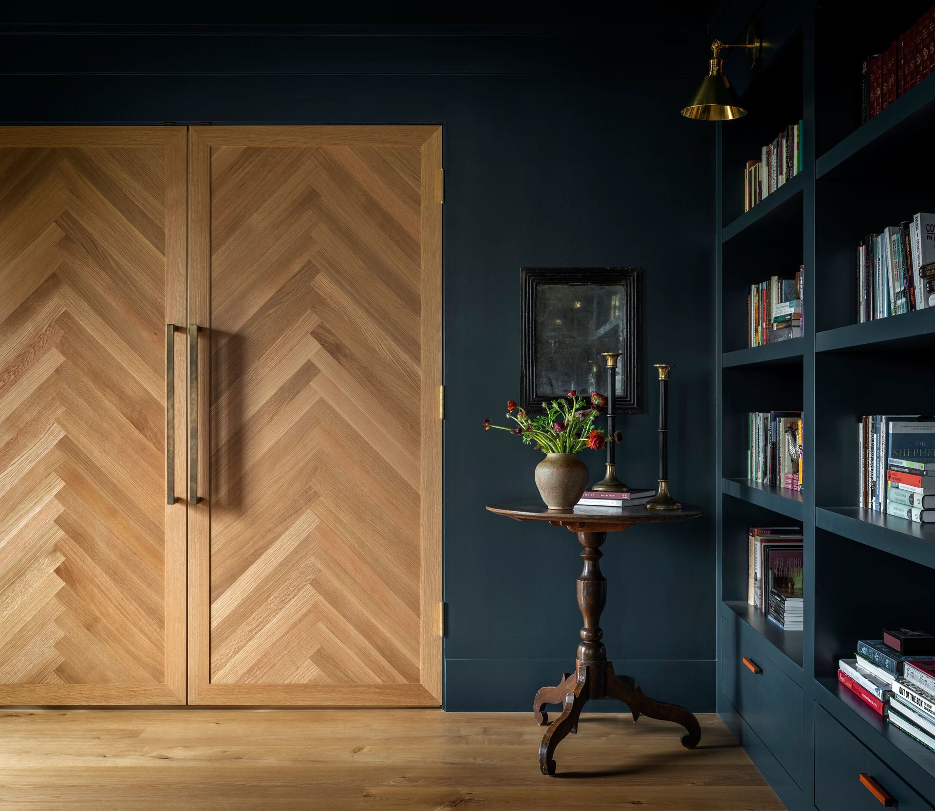 there is a table in the middle of the room with a vase of flowers on it