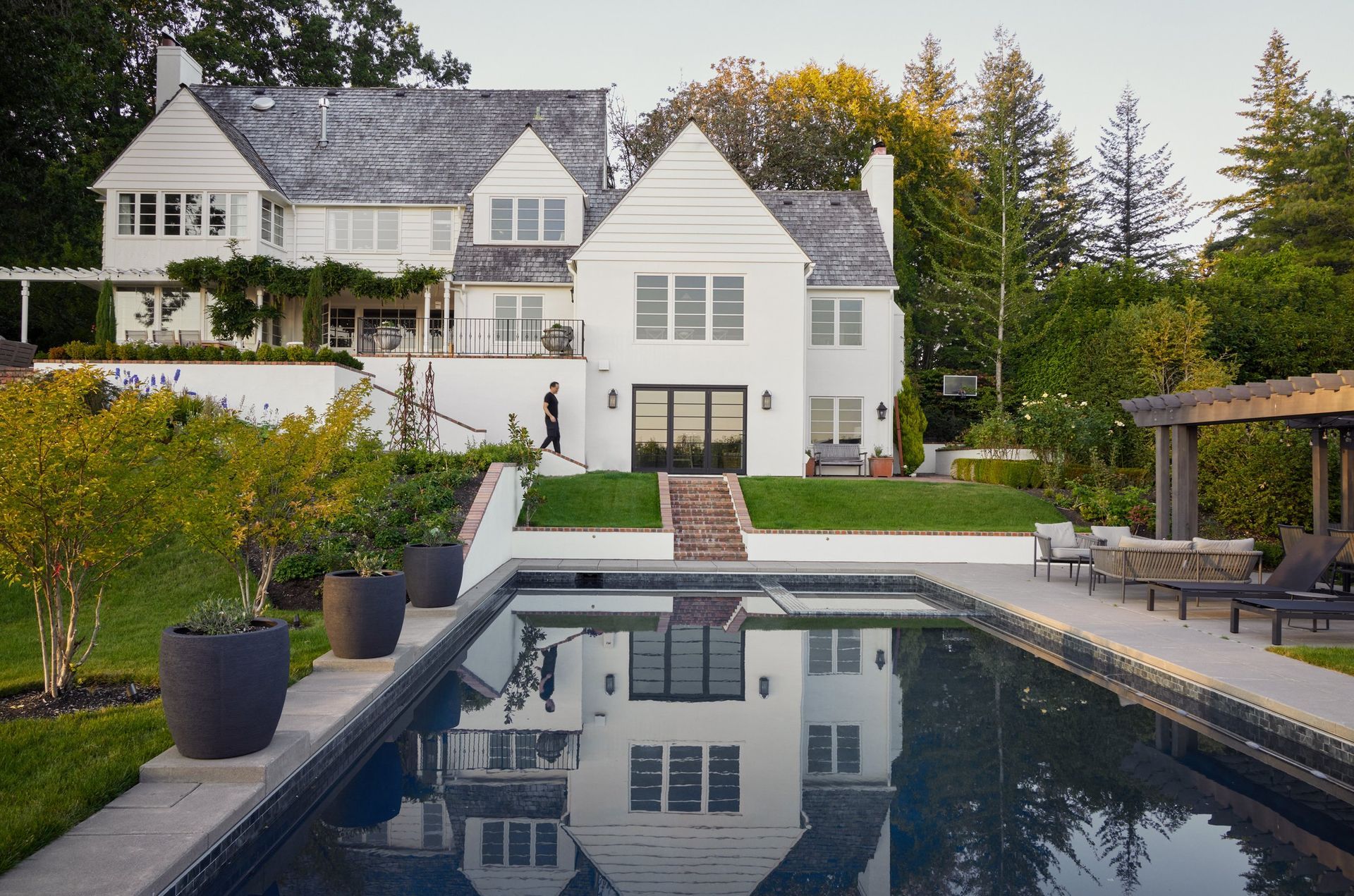 a large white house with a large swimming pool in front of it