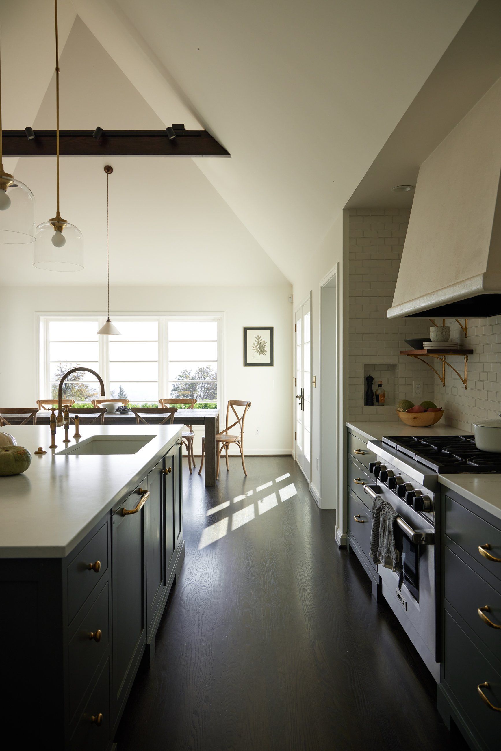 a kitchen with a stove top oven and a sink