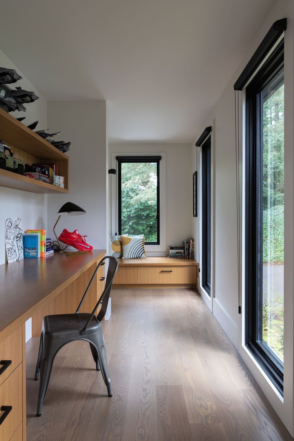 a room with a desk and chair and a window