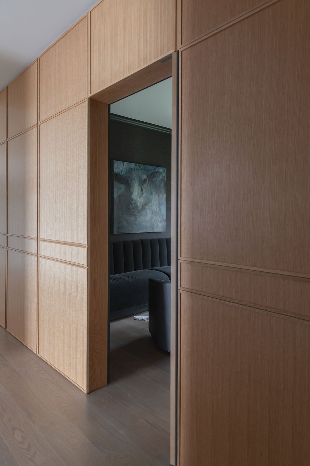 a hallway with wooden walls and a door leading to a room