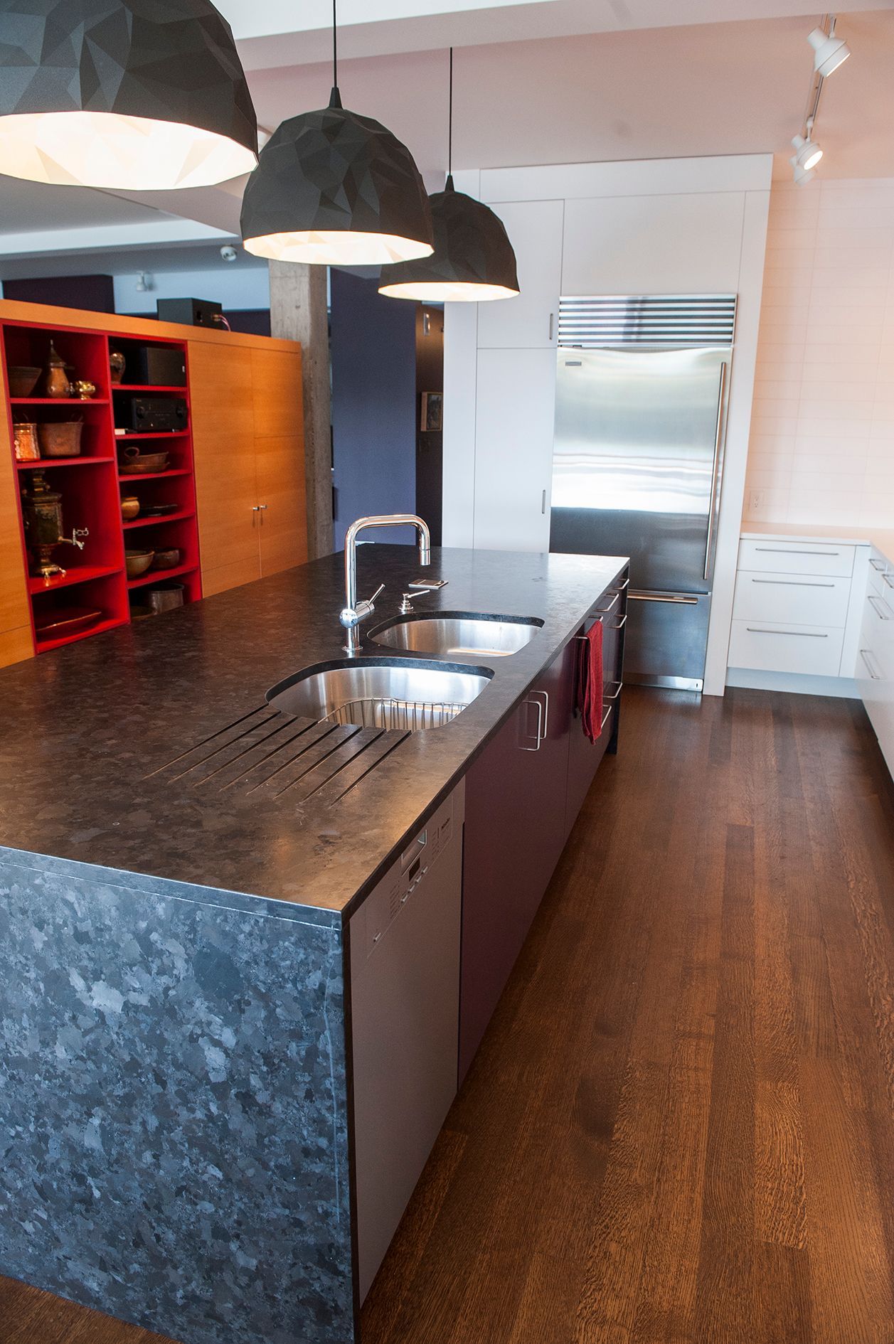 a kitchen with a large island and two sinks