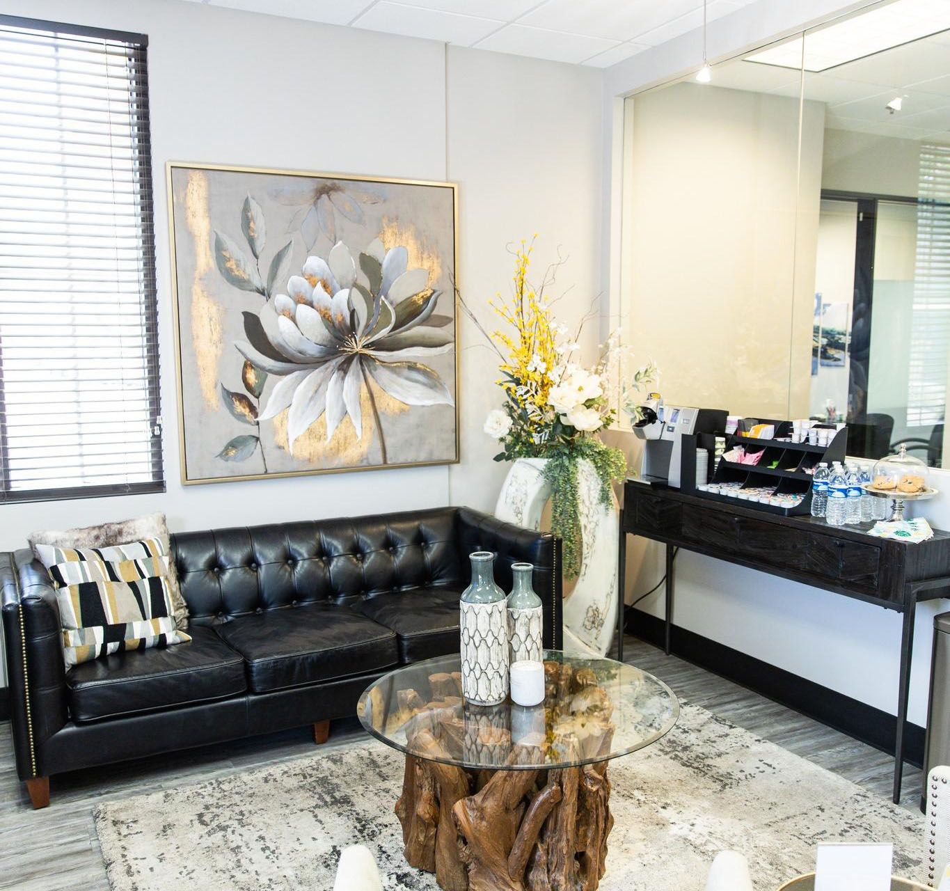 A waiting room area with a couch and a coffee table