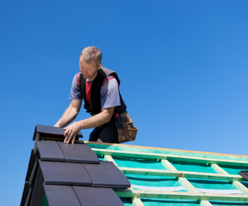 roofer installing roof tiles