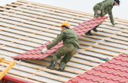 Contractors installing roof tiles