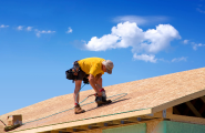 worker installing roof tiles