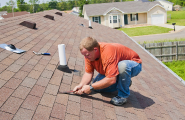 roofer inspecting roof for damage or leaks