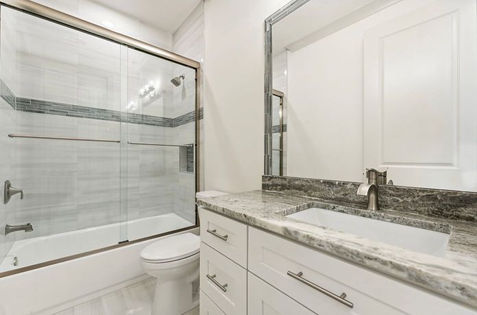A bathroom with a sink , toilet , bathtub and shower.