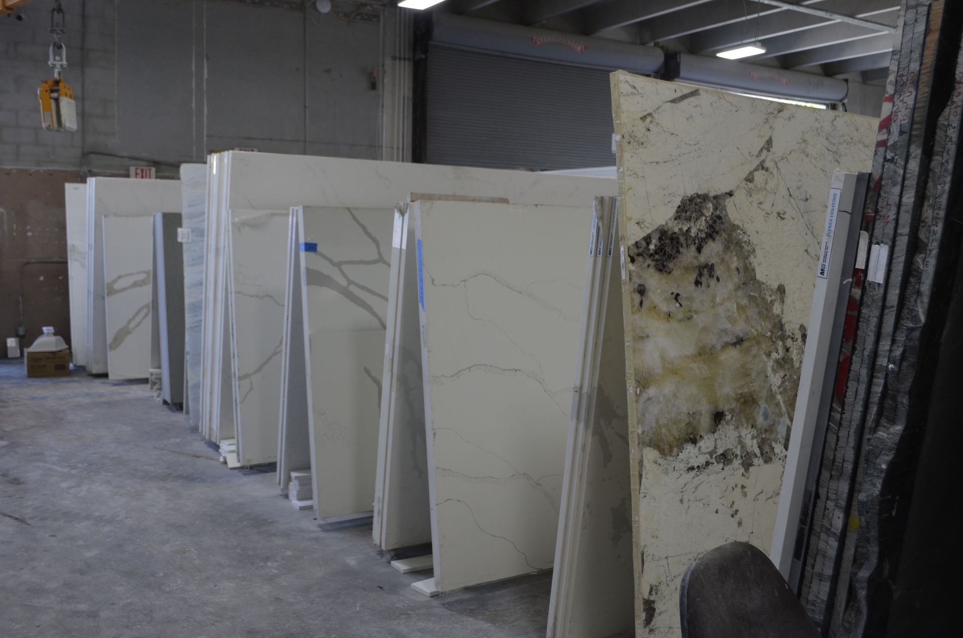 Large slabs of white stone standing in a warehouse