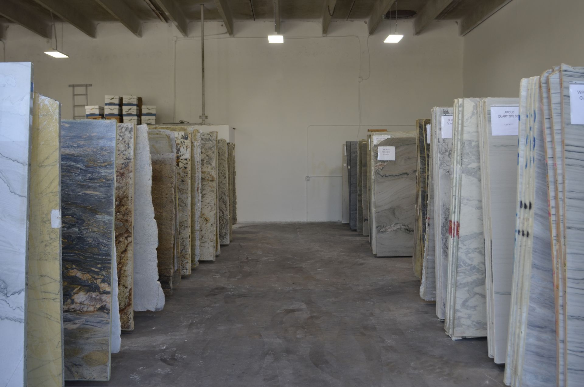 Rows of upright granite slabs in a showroom
