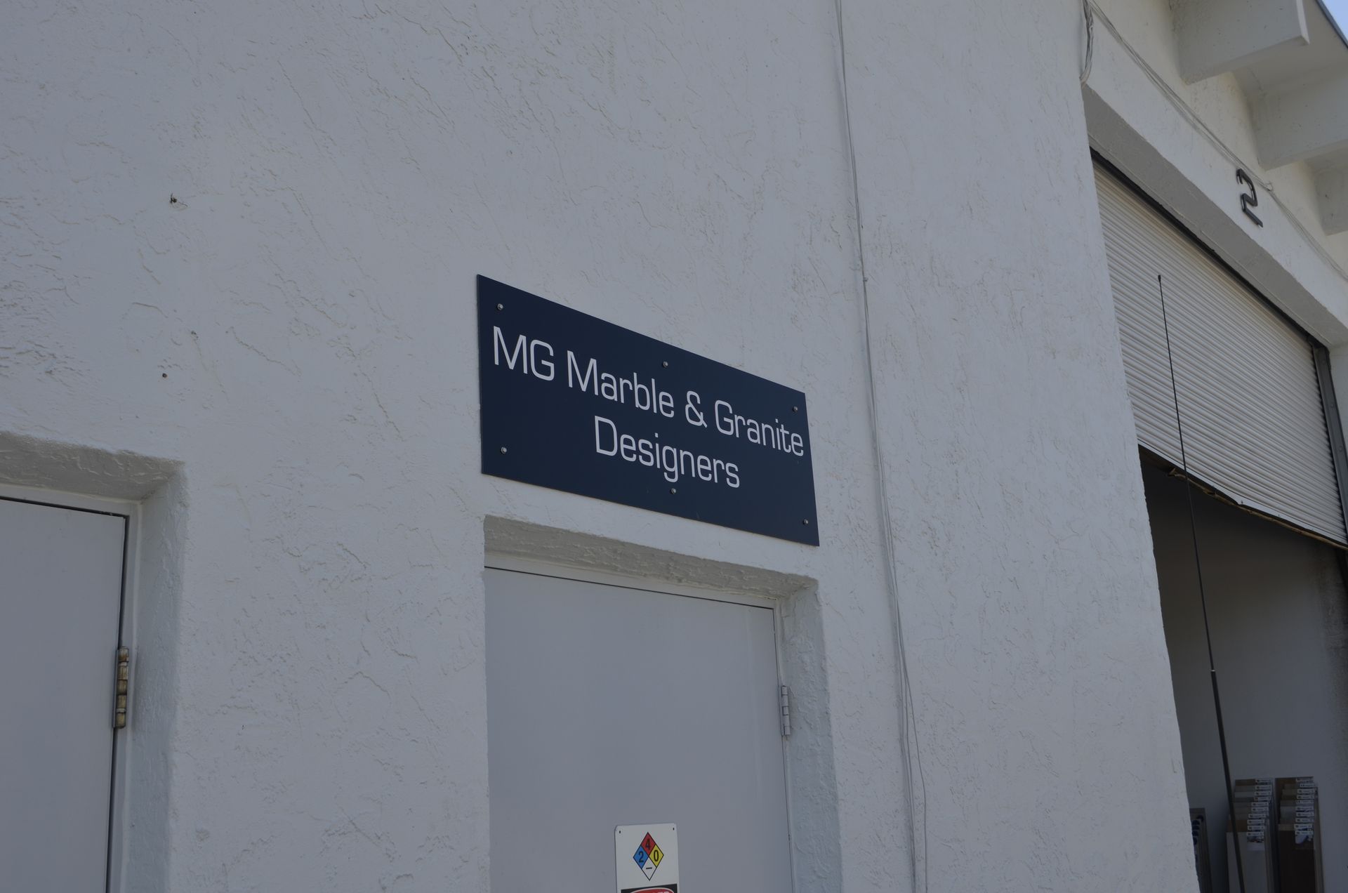 Sign on a white building reads 