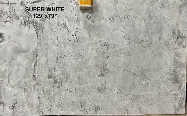 Large slab of Super White marble, predominantly gray and white with veining