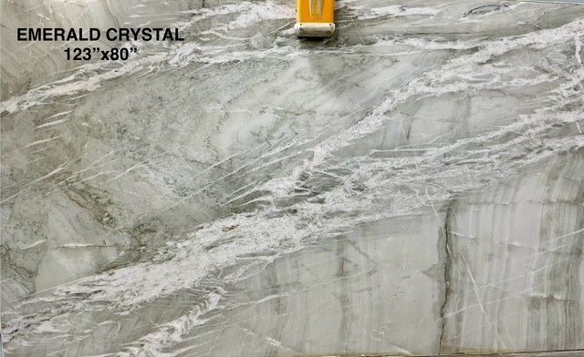 Emerald Crystal slab light green and white marble with a swirling pattern