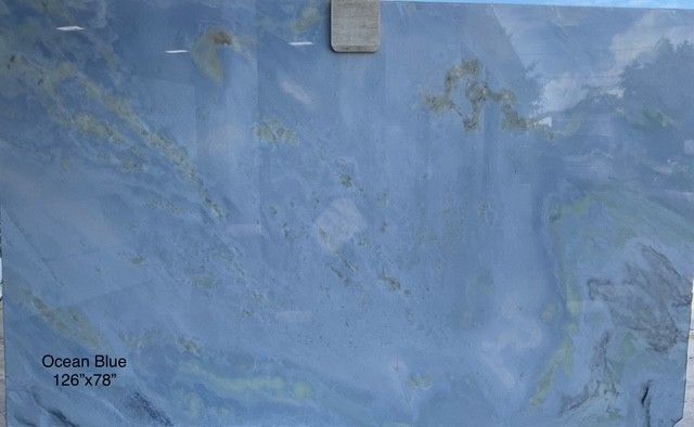 Ocean Blue slab of stone with a gradient of blue, with yellow and green veining.