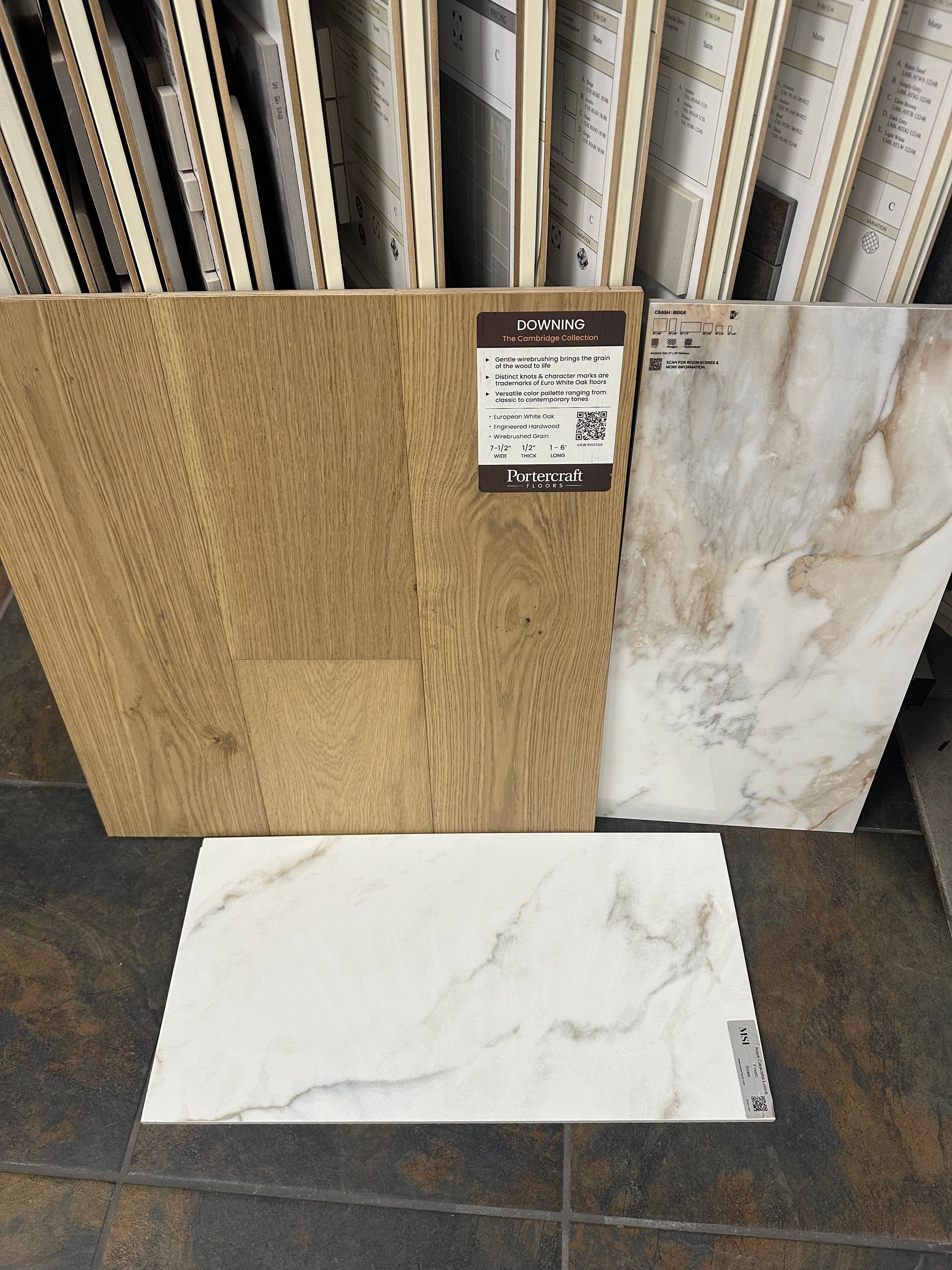 Three tile samples: wood-look, marble-veined, and solid marble-look, displayed in a store.