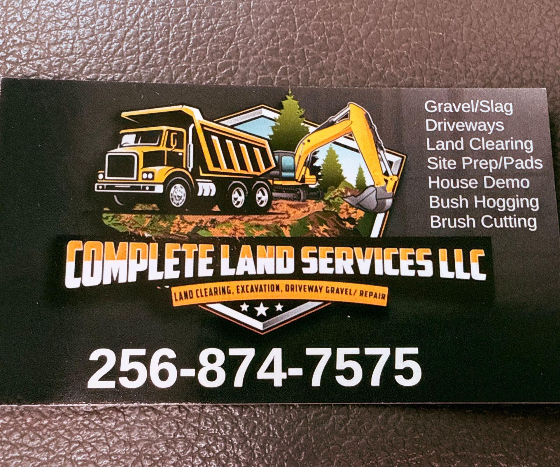 Business card for Complete Land Services LLC; features a dump truck and excavator, contact info.