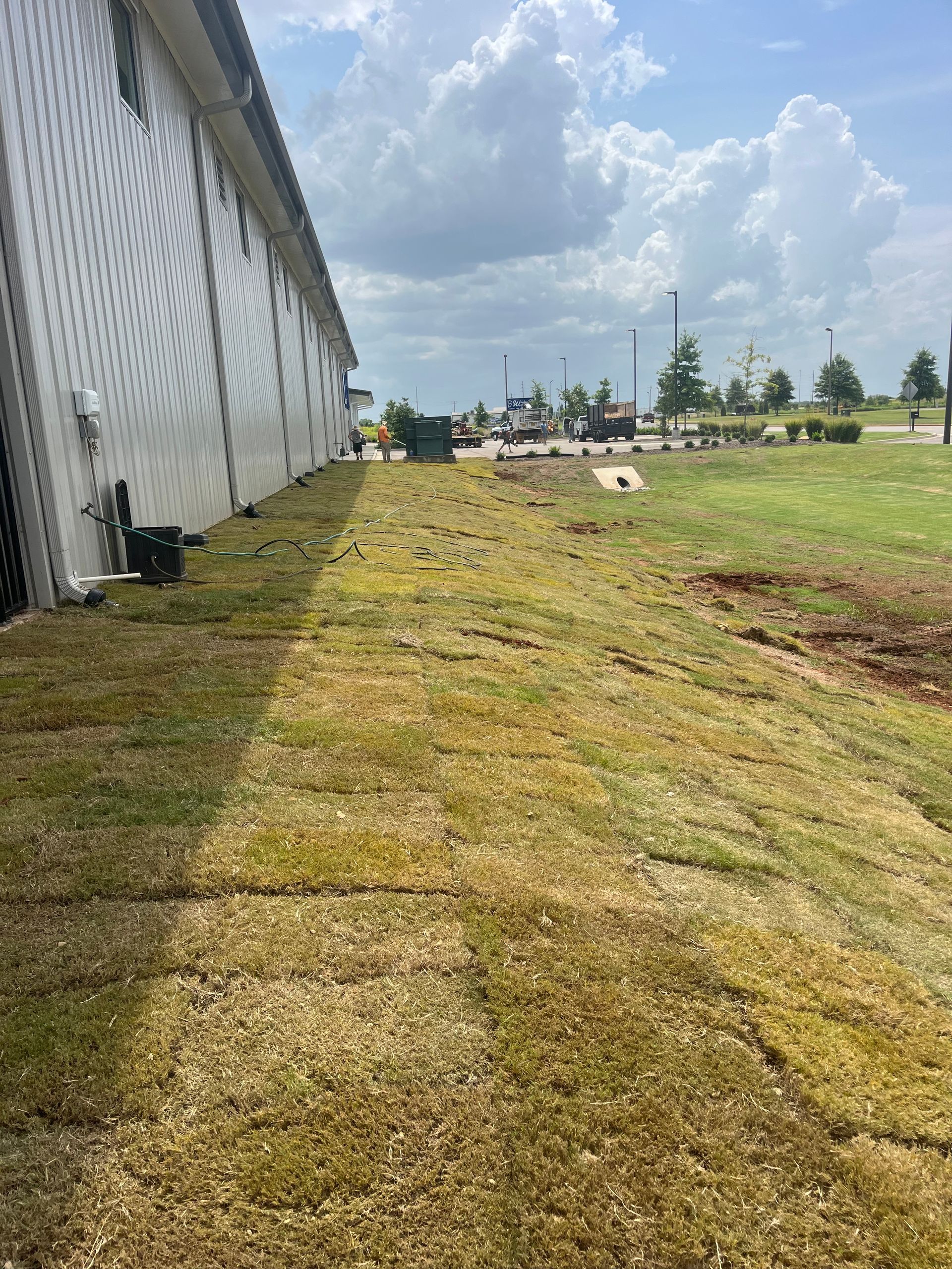 A large white building with a lot of grass in front of it.