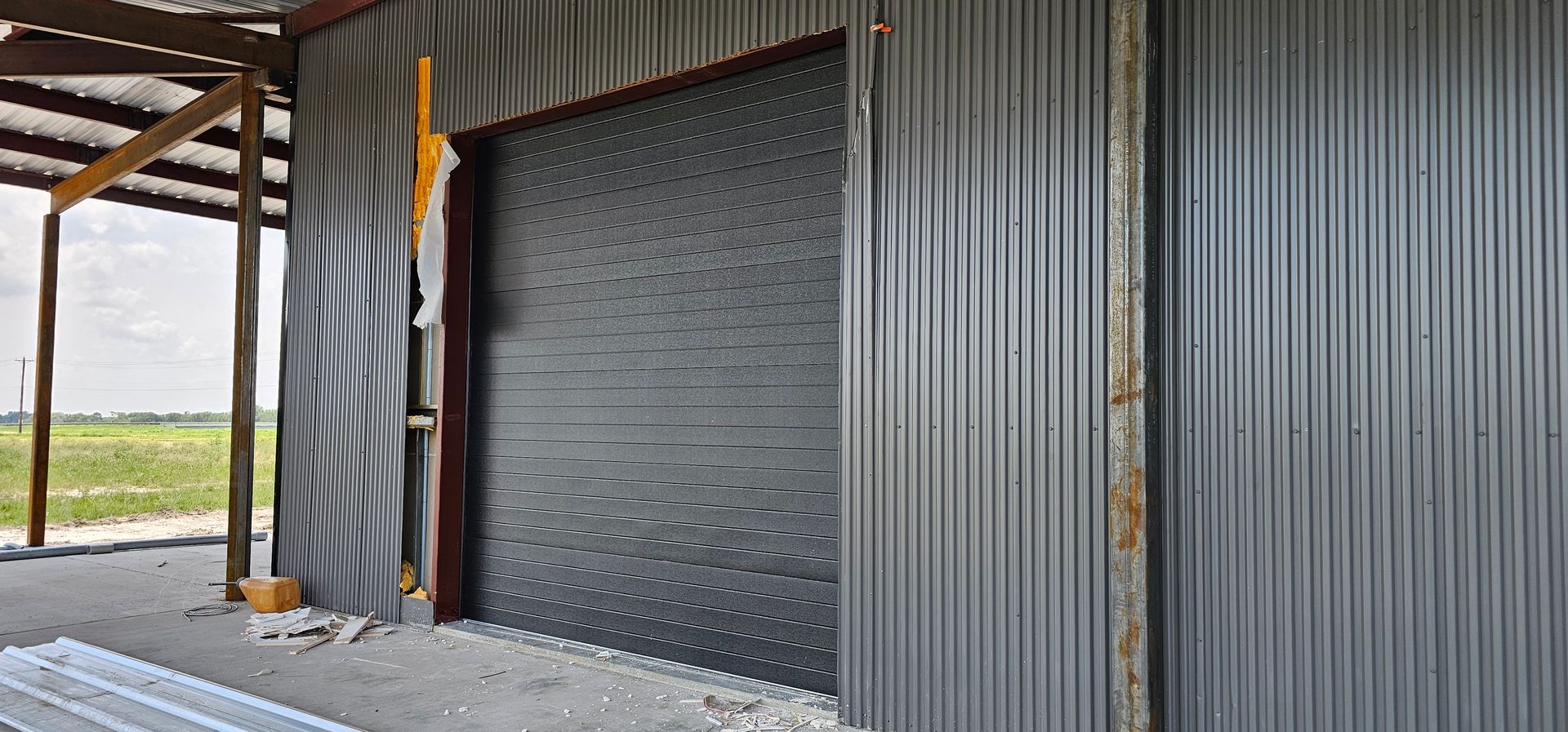 A garage door is being built out of corrugated metal.