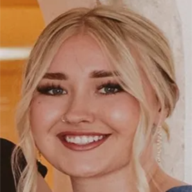 Hannah McLane with a nose ring smiles at the camera.