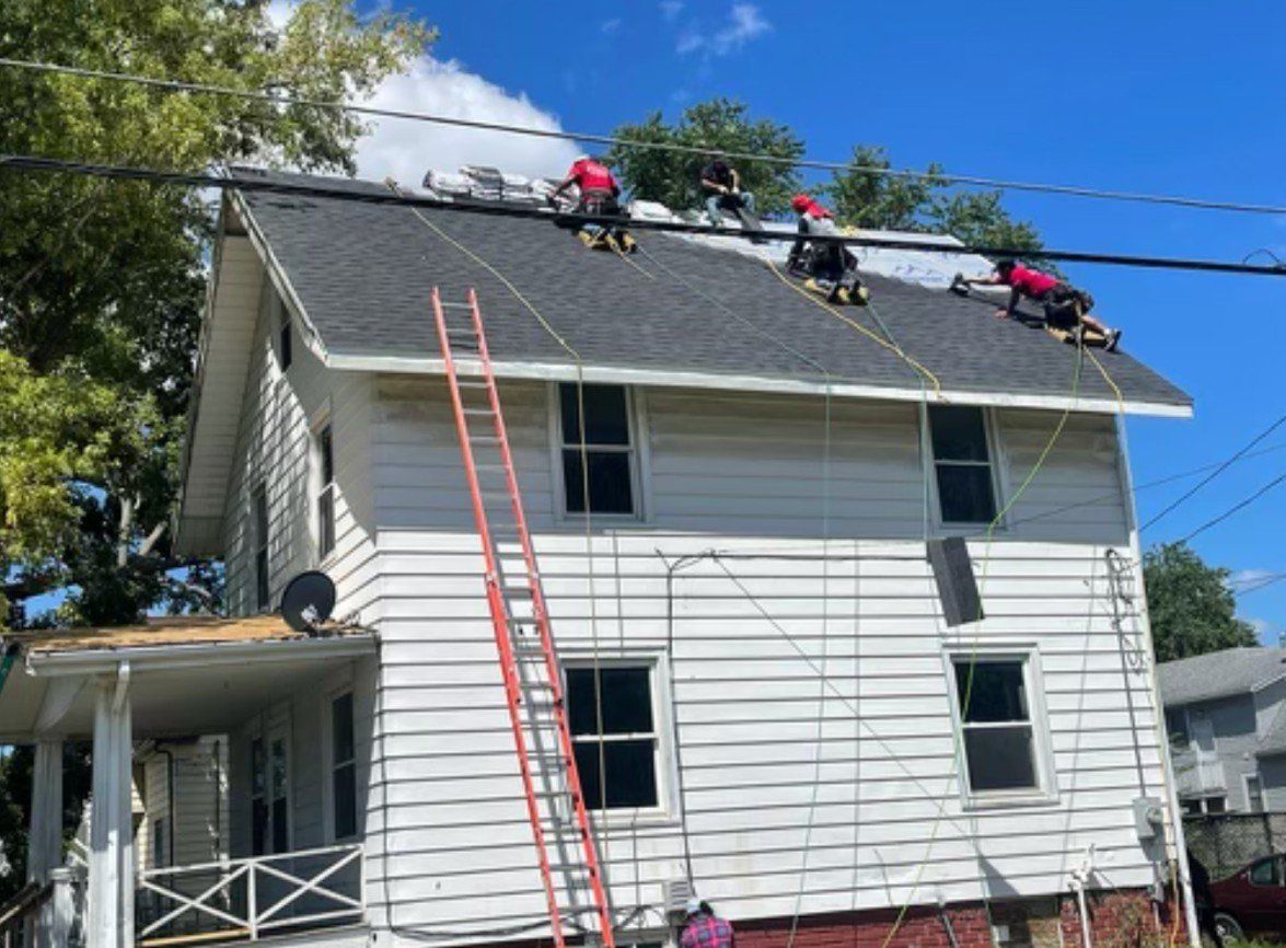 Roof work on 2 story white house