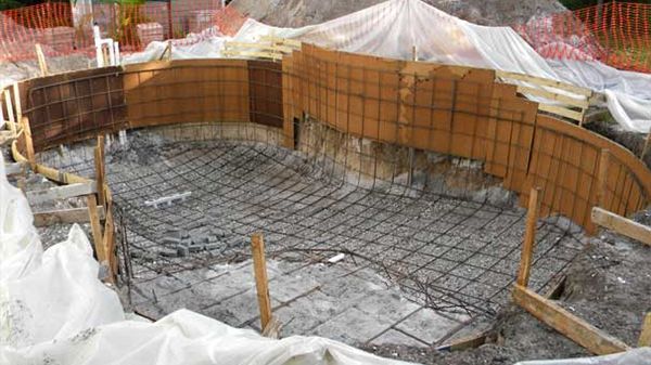 A swimming pool is being built in the ground.