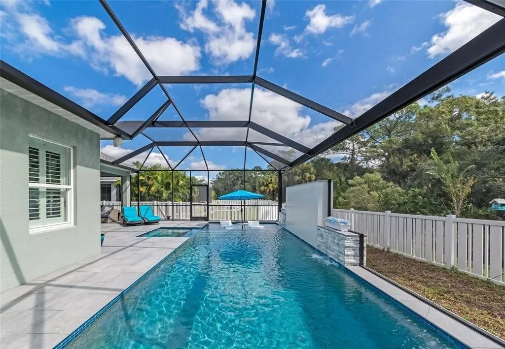 A large swimming pool in the backyard of a house