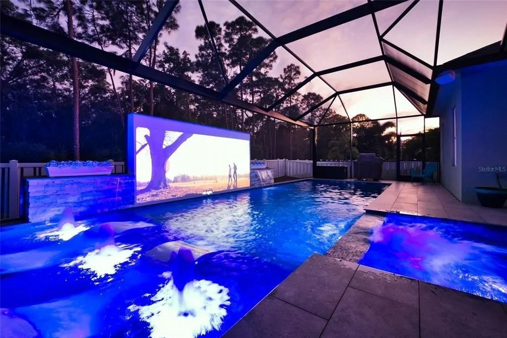 A large swimming pool with a projector screen behind it