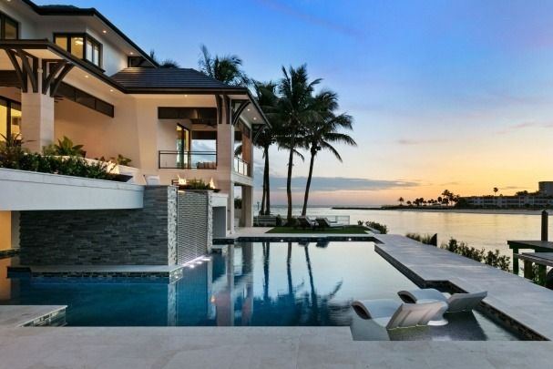 A large house with a swimming pool in front of it