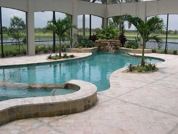 A large swimming pool with a waterfall in the middle