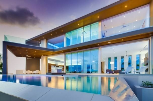 A large house with a swimming pool in front of it