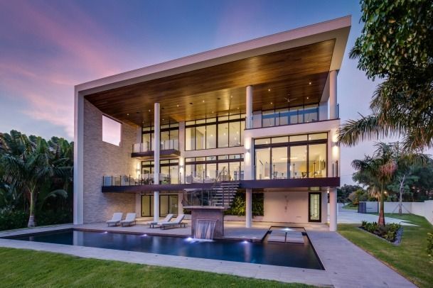 A large house with a swimming pool in front of it.