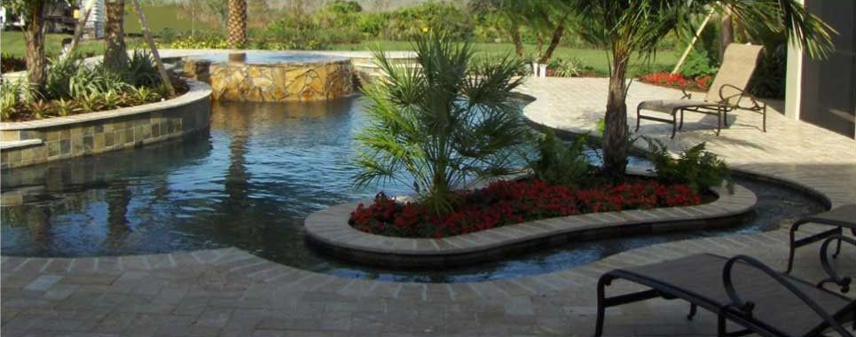 A large swimming pool surrounded by lawn chairs and palm trees.