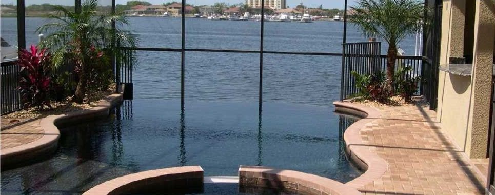 A swimming pool with a view of a body of water