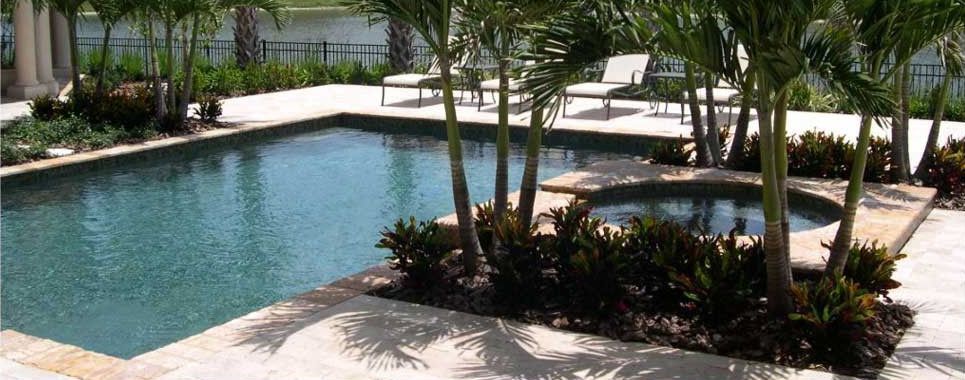 A large swimming pool surrounded by trees and chairs
