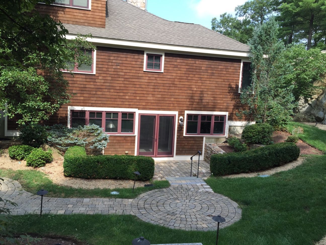 A large brick house with a patio in front of it