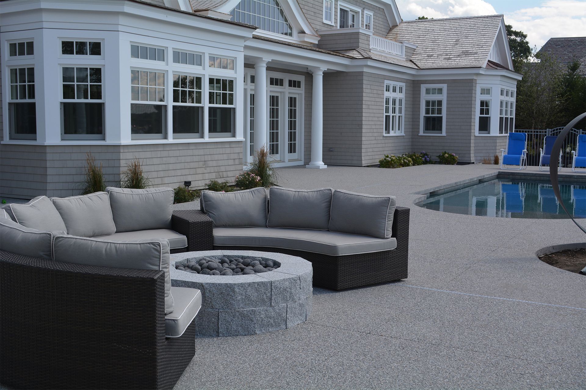 A large house with a fire pit in front of it