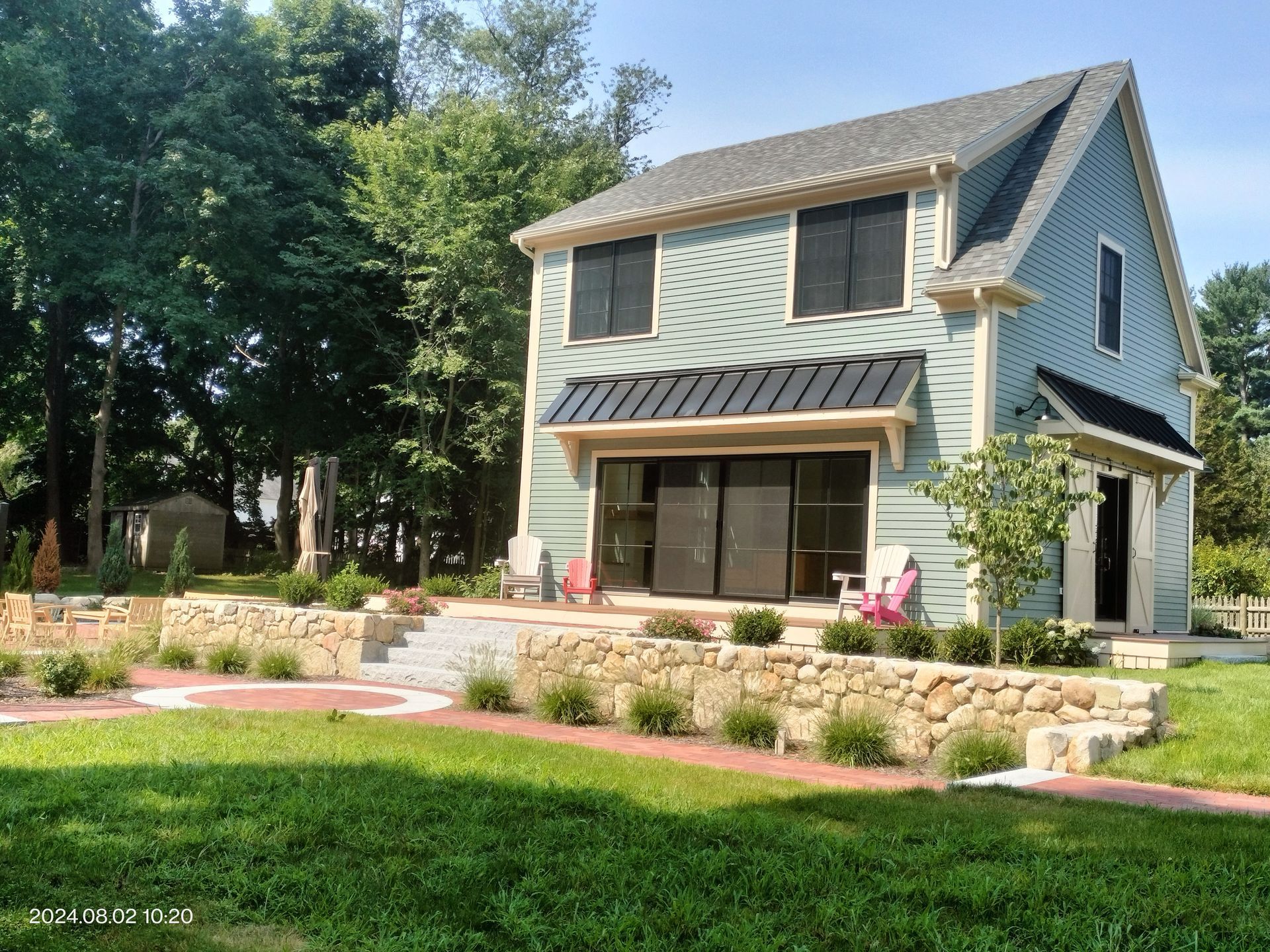 A small house with a large lawn in front of it.