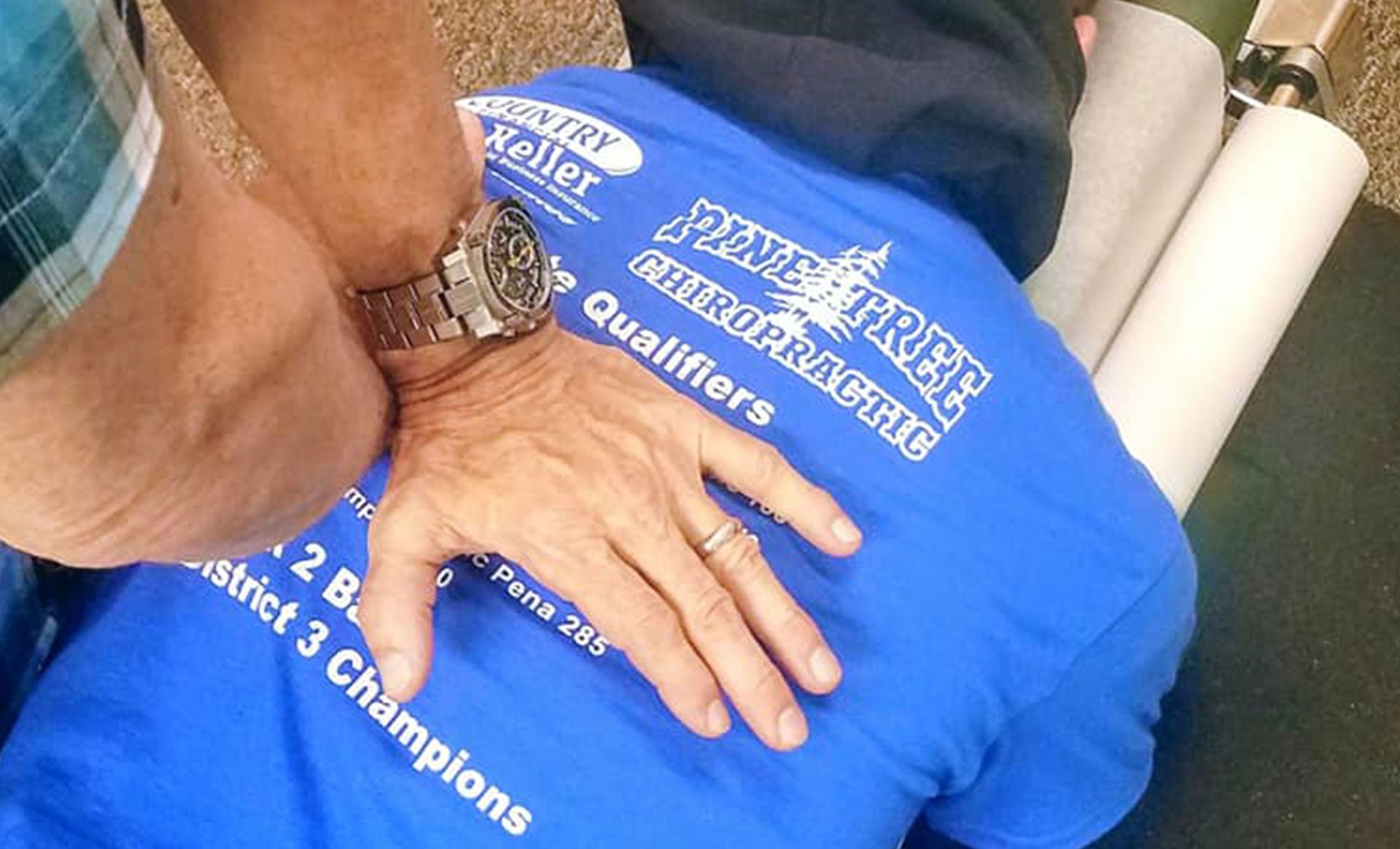 Chiropractor adjusting a person's back.