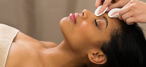 A woman is getting a facial treatment at a spa.