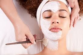 A woman is getting a facial treatment at a spa.