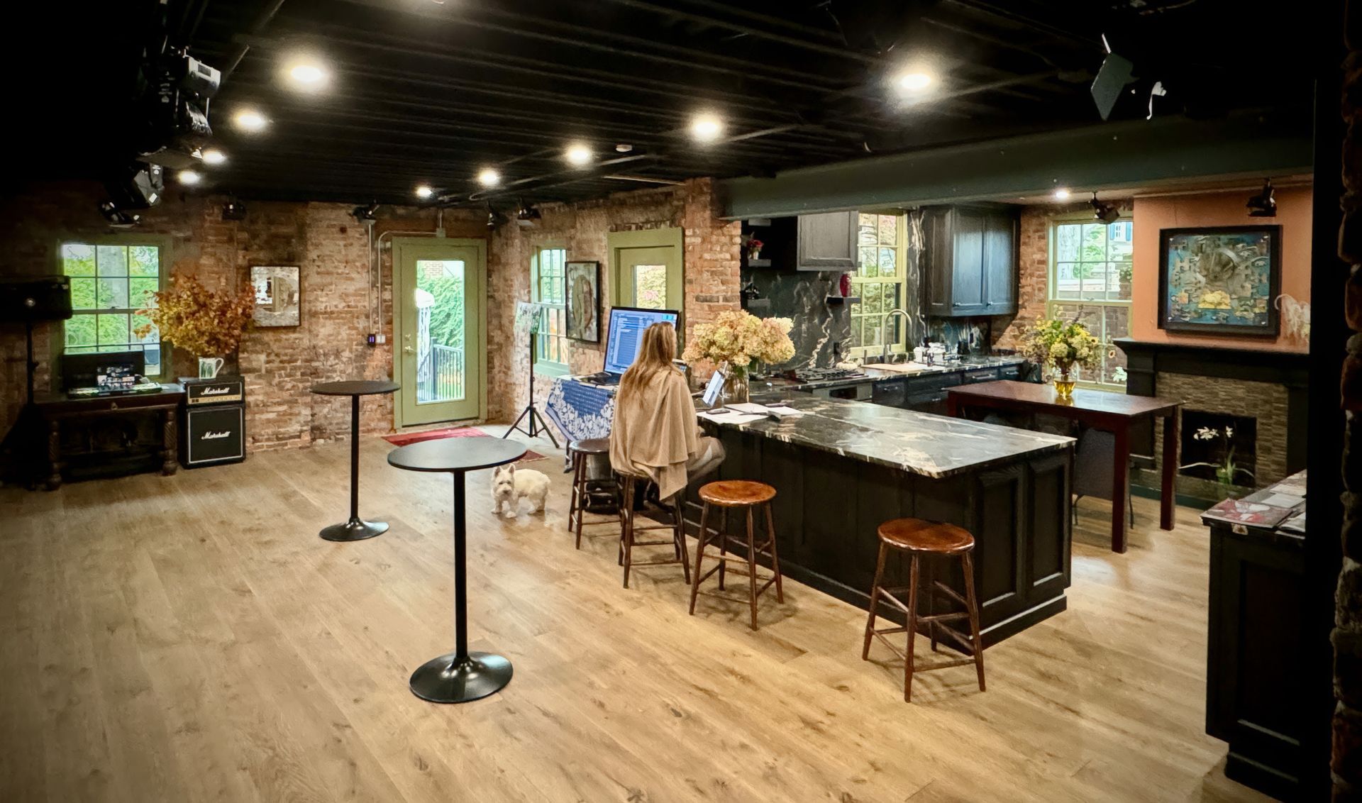 A woman is sitting at a table in a large room.